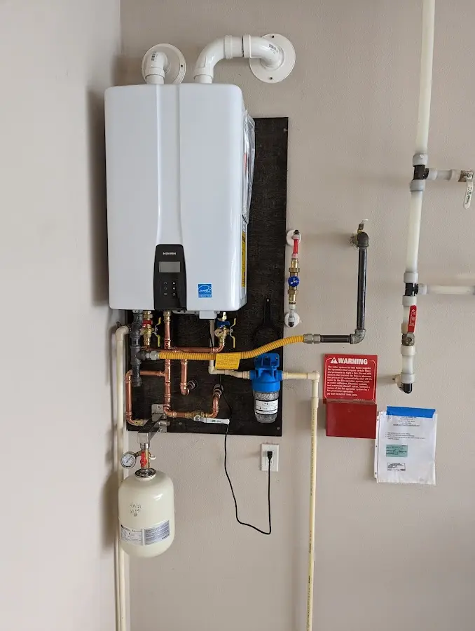Professional plumber installing copper piping in a Evesham home